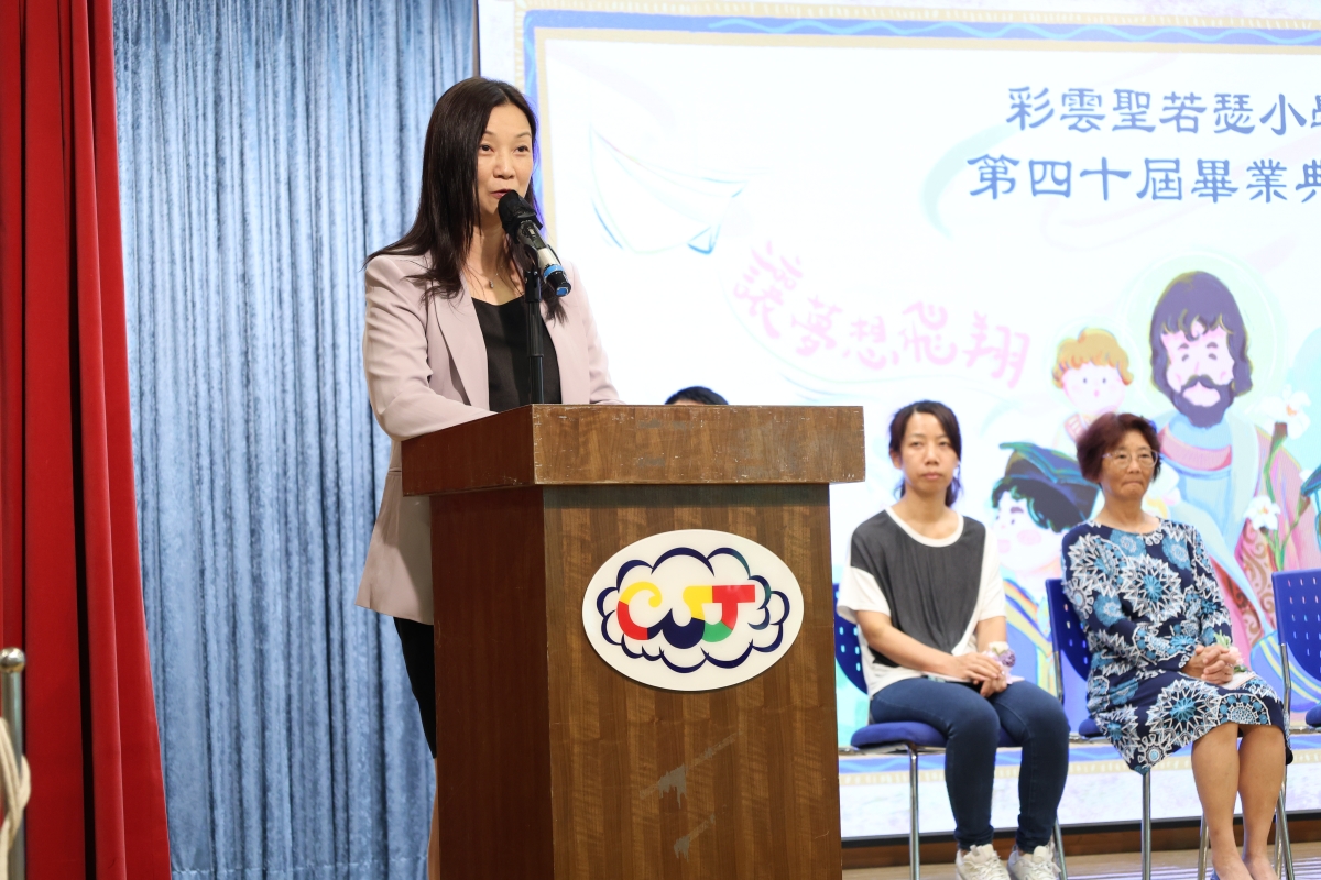 A person standing at a podium speaking into a microphoneDescription automatically generated